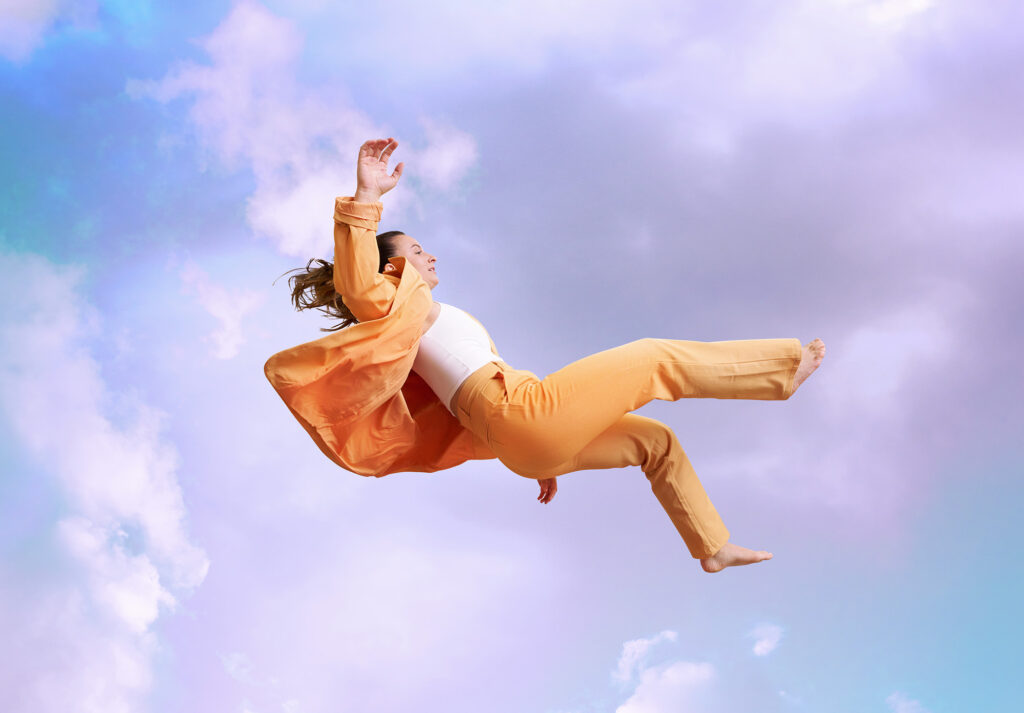 Woman falling through clouds