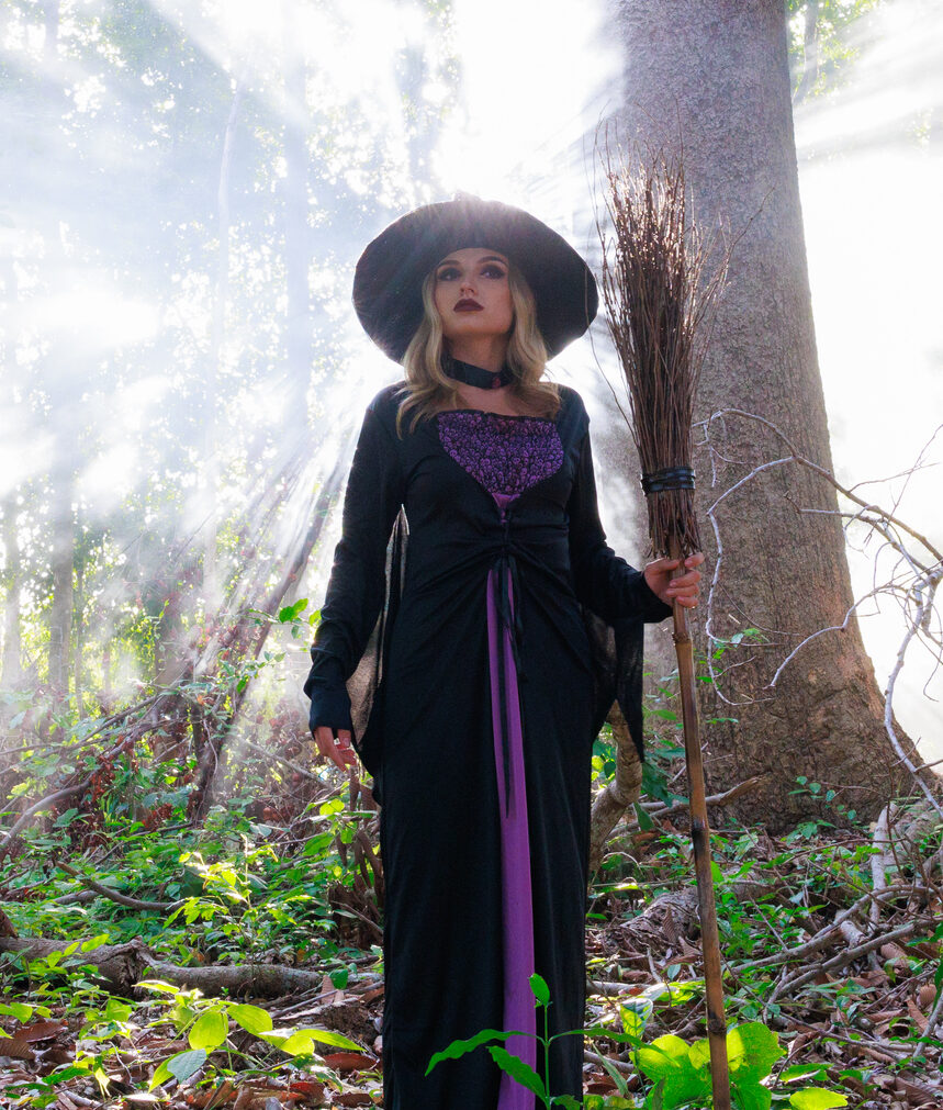 Magical Halloween Adventure: Enchantress in Witch Costume Roaming Forest