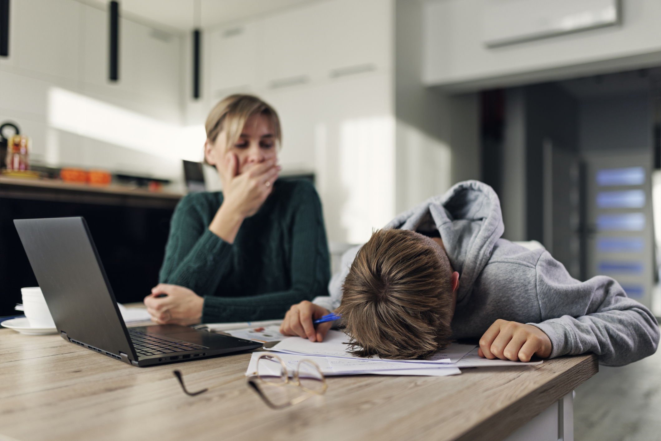 Frustrated mother helping frustrated son with some very difficult homework