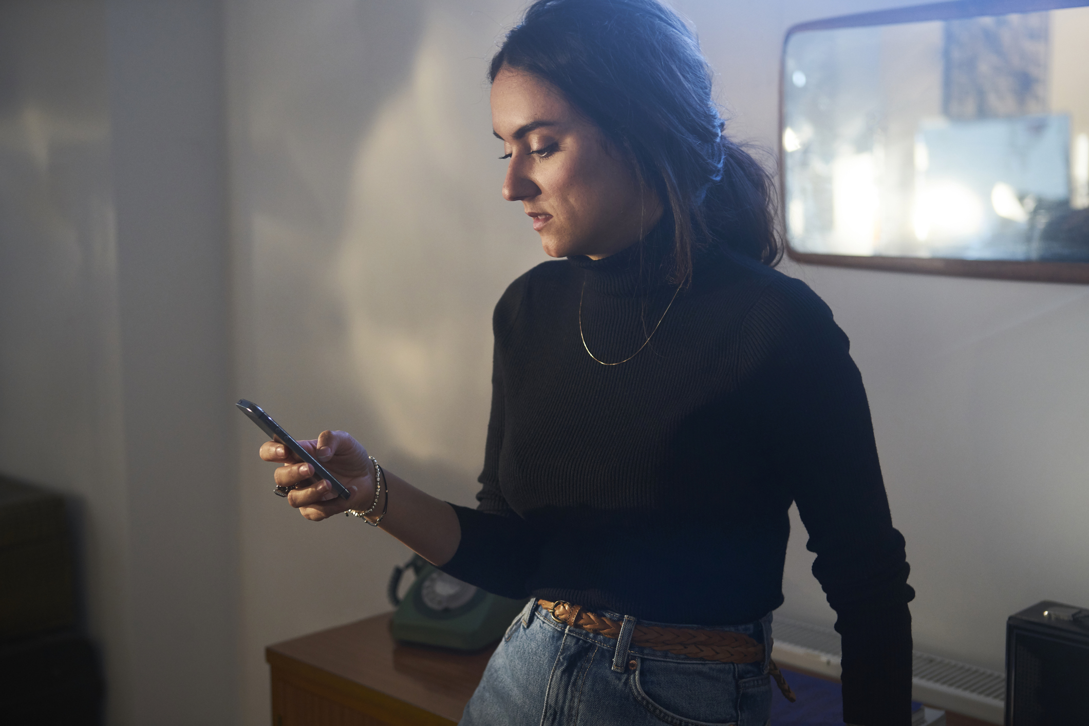 Woman using a smart phone unhappy in trendy east london