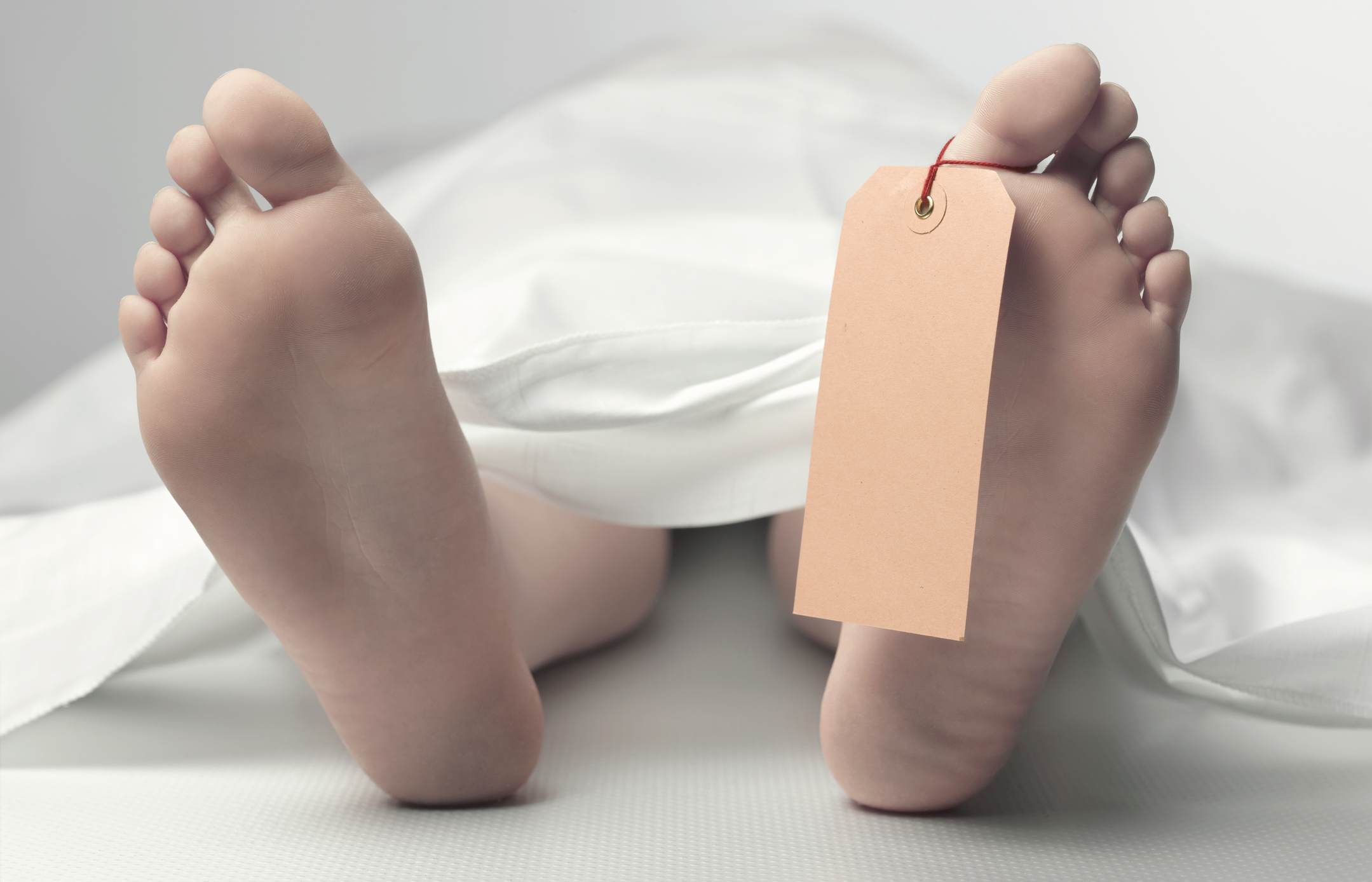 Teenage feet in morgue with copy space