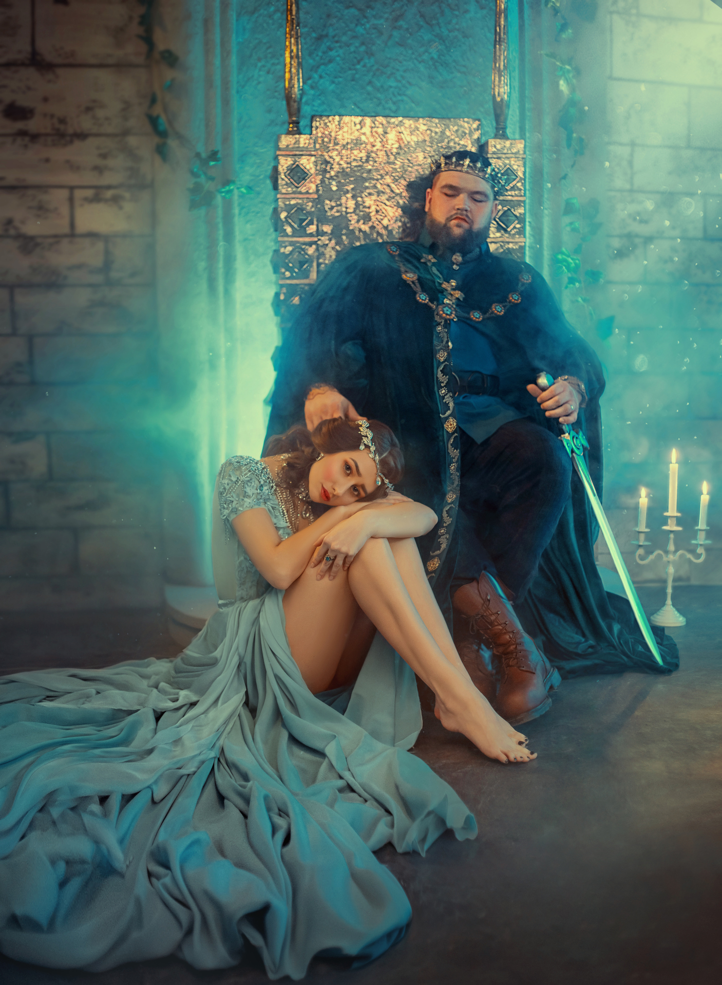 sad miserable offended woman queen victim of dictator domineering man. Power King in golden crown sits on iron throne inside castle medieval old room. Luxury royal clothing. Romantic scandal quarrel