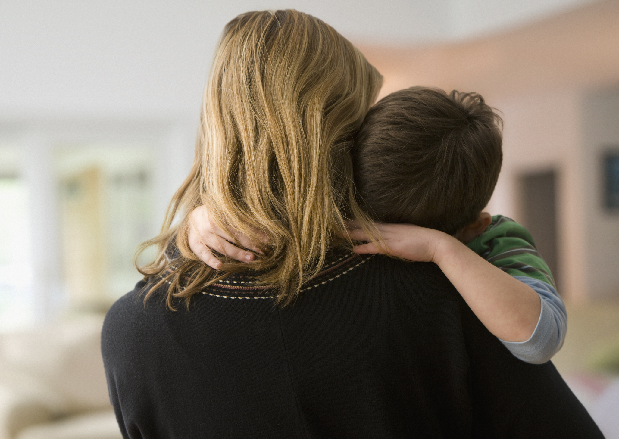 Caucasian mother comforting son Jennifer Aniston
