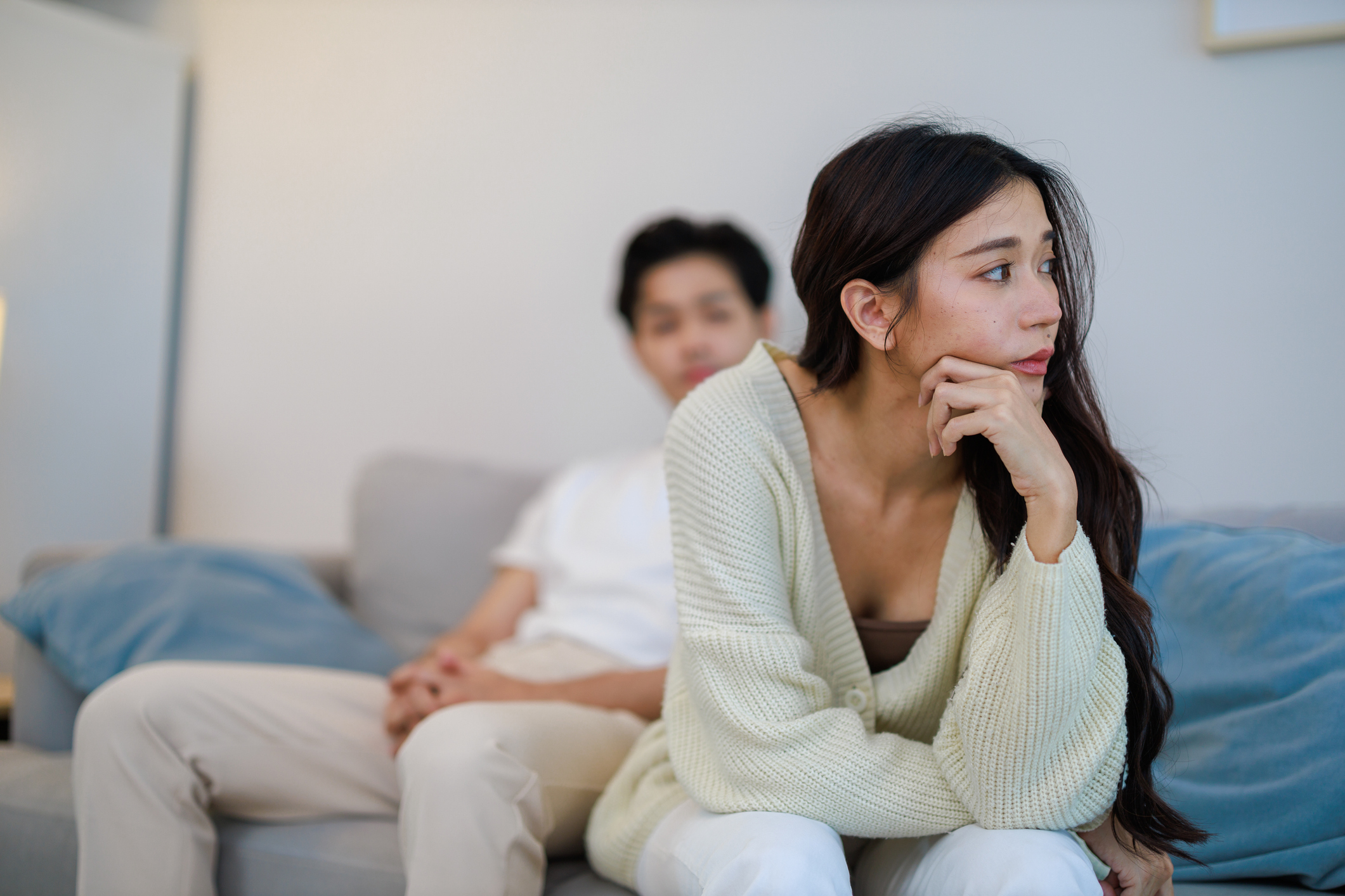 The Asian couple getting upset with each other in bedroom. Married couple