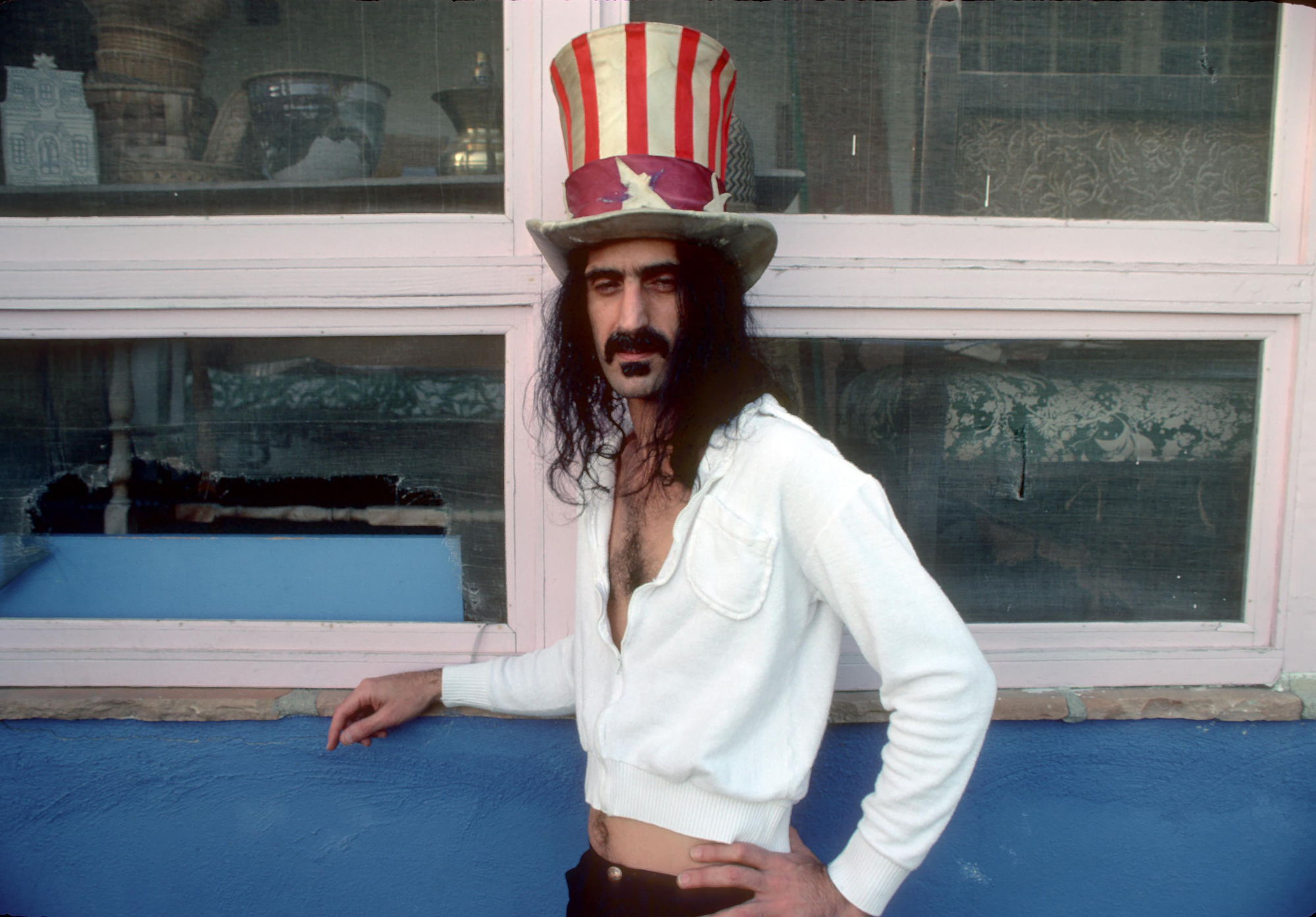 Uncle Zappa Wants You Frank Zappa poses for a portrait wearing an Uncle Sam stars and stripes top hat in March 1979